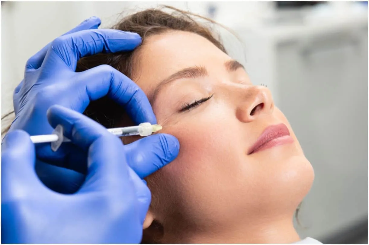  young woman is getting a rejuvenating facial injections